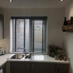 Grey kitchen venetian blinds in a neutral kitchen
