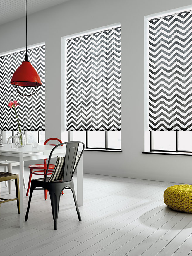 Black and white aztec printed roller blinds in a white kitchen area