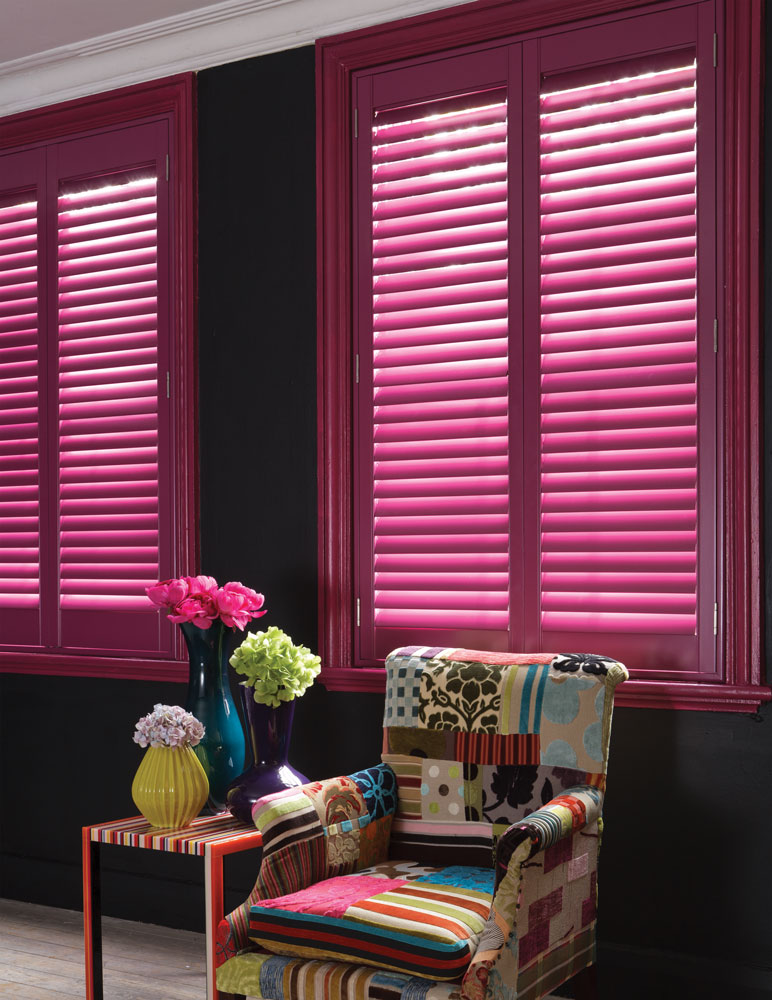 Pink shutter feature image with multi coloured chair in social area