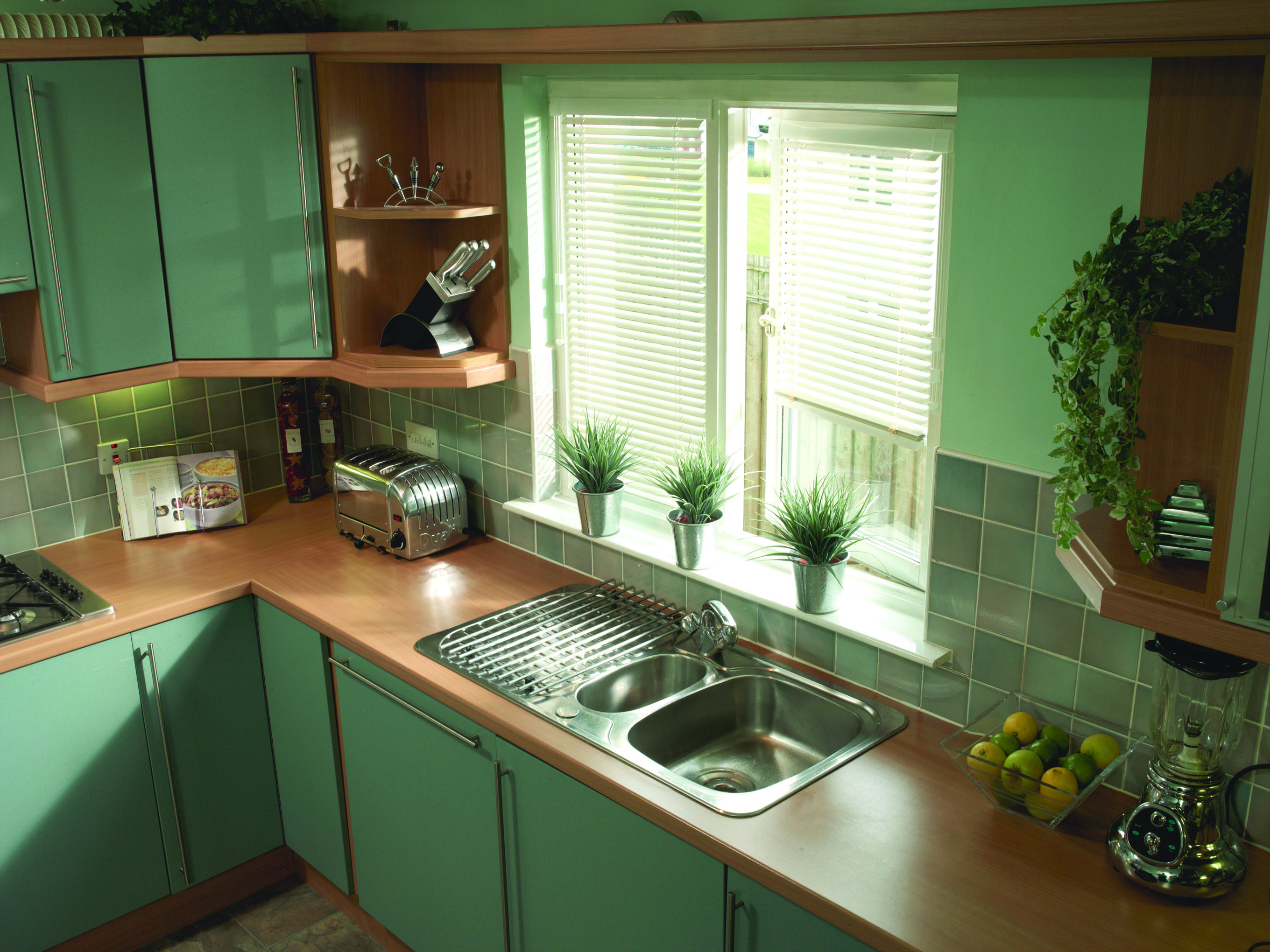 Window blinds Coventry. Venetian white blinds in green kitchen.