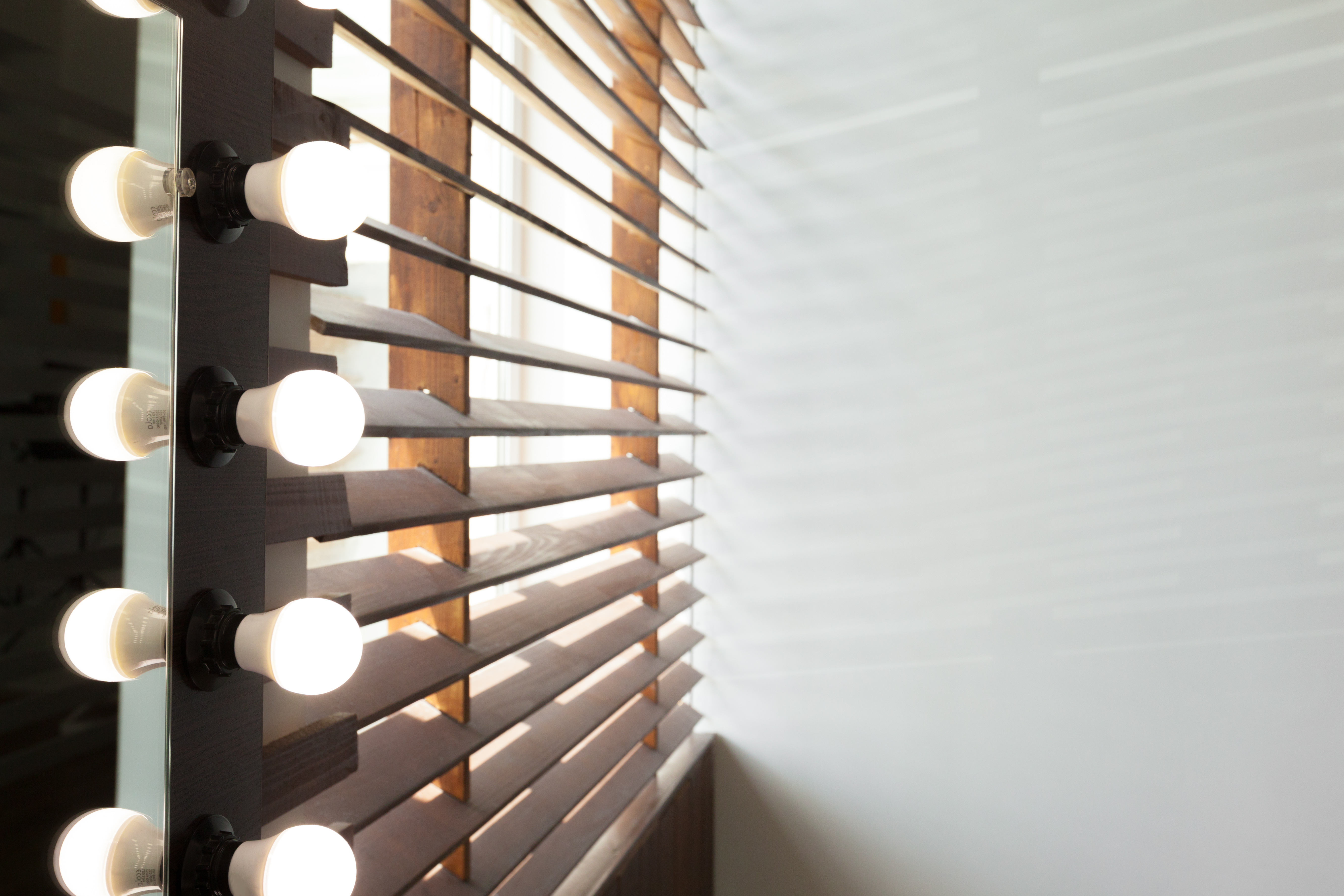 Wooden blinds with sun light in a house room